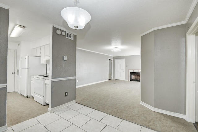 interior space with a tiled fireplace, baseboards, light colored carpet, visible vents, and ornamental molding