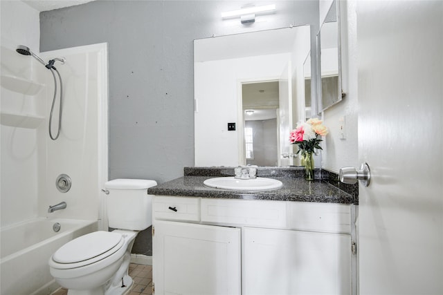 full bath featuring toilet, vanity, tile patterned flooring, and washtub / shower combination