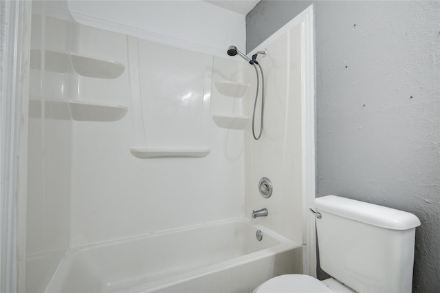 full bathroom with toilet and a textured wall