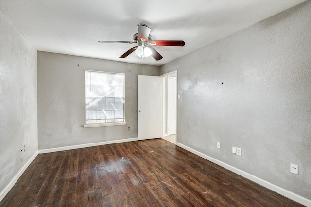 unfurnished room featuring baseboards, a textured wall, hardwood / wood-style flooring, and a ceiling fan