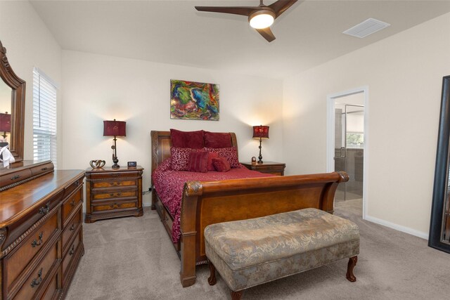 3311 Passage Ln, Conroe, TX 77301 - bedroom with light carpet, multiple windows, ensuite bathroom, and baseboards