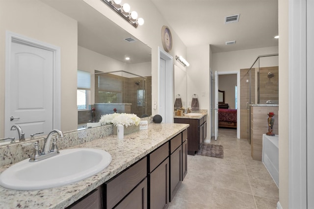 3311 Passage Ln, Conroe, TX 77301 - ensuite bathroom featuring a stall shower, vanity, and tile patterned flooring