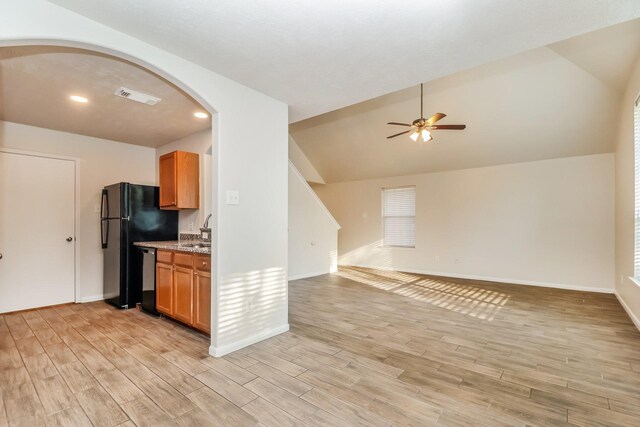 kitchen with a sink, black dishwasher, visible vents, arched walkways, and ceiling fan