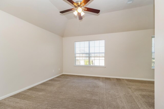 unfurnished room featuring carpet floors, baseboards, vaulted ceiling, and ceiling fan