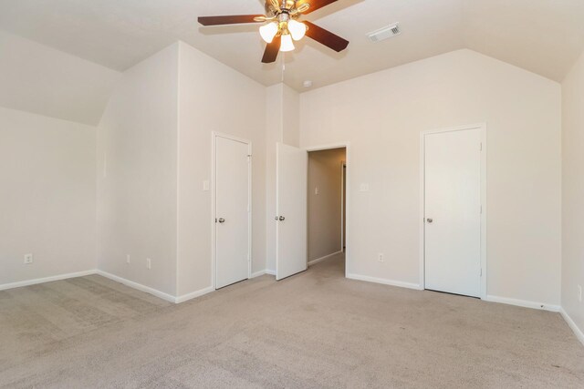 unfurnished bedroom featuring high vaulted ceiling, a ceiling fan, light carpet, baseboards, and visible vents