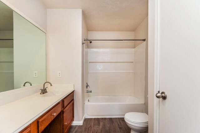 full bath with toilet, vanity, shower / bathtub combination, and wood finished floors