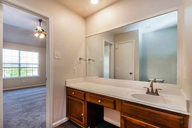 bathroom featuring baseboards, visible vents, ceiling fan, and vanity