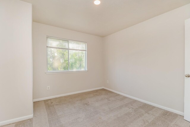 unfurnished room featuring carpet flooring and baseboards