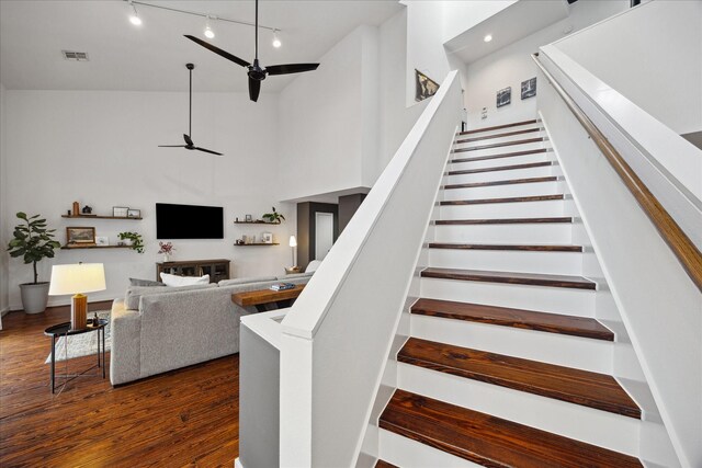 2976 Commerce St, Houston, TX 77003 - stairway featuring a ceiling fan, track lighting, high vaulted ceiling, and wood finished floors