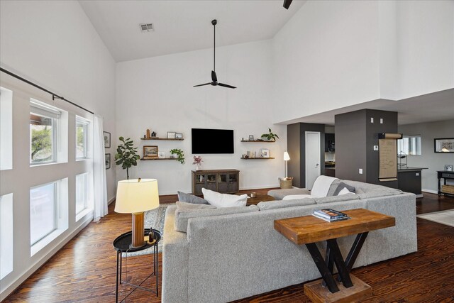 2976 Commerce St, Houston, TX 77003 - living area with high vaulted ceiling, dark wood-style floors, baseboards, and ceiling fan