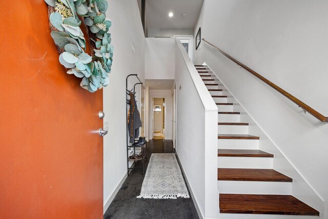 2976 Commerce St, Houston, TX 77003 - stairway featuring baseboards, a towering ceiling, and recessed lighting