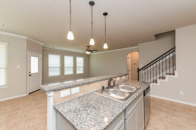 5911 Grantgrala Dr, Katy, TX 77493 - kitchen with baseboards, ceiling fan, arched walkways, a sink, and stainless steel dishwasher