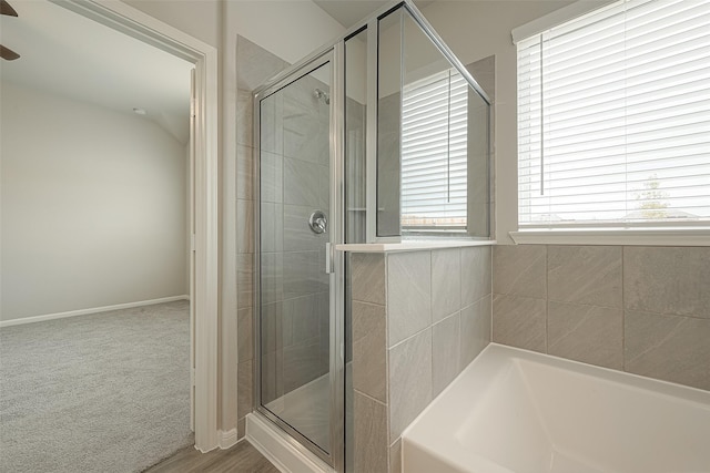 full bath with a shower stall, baseboards, a bath, and a ceiling fan