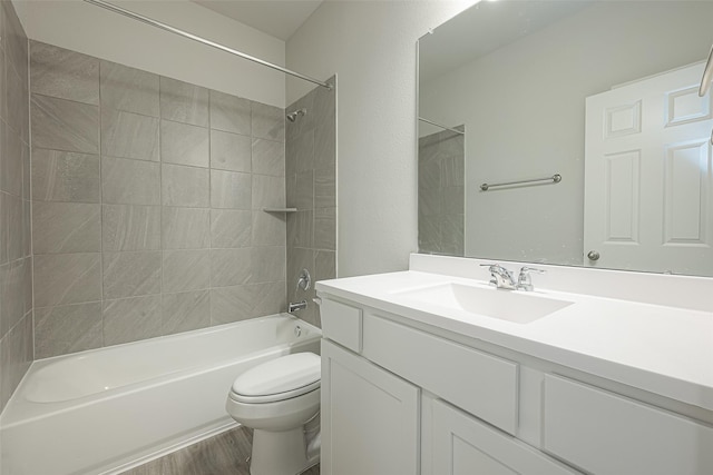 bathroom with toilet, vanity, shower / bath combination, and wood finished floors