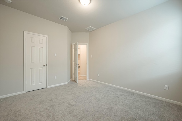 unfurnished bedroom with baseboards, visible vents, and carpet floors