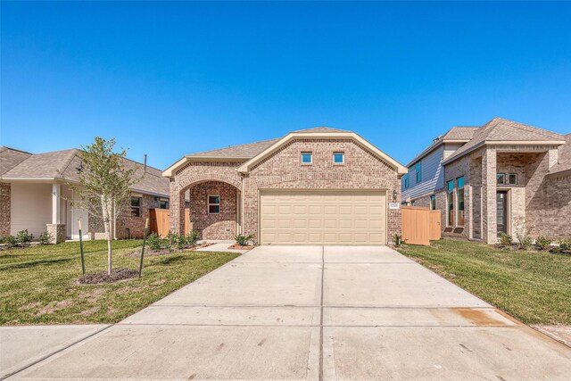 12351 Sterling Oak Dr, Humble, TX 77044 - view of front of property with driveway, brick siding, a front lawn, and an attached garage