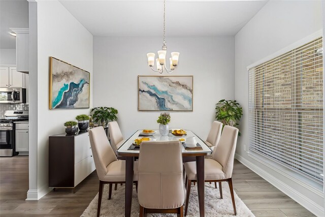 4210 Leslies Way, Dickinson, TX 77539 - dining area featuring a chandelier, wood finished floors, and baseboards