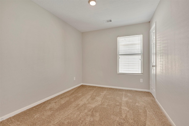 unfurnished room featuring baseboards, carpet flooring, and visible vents