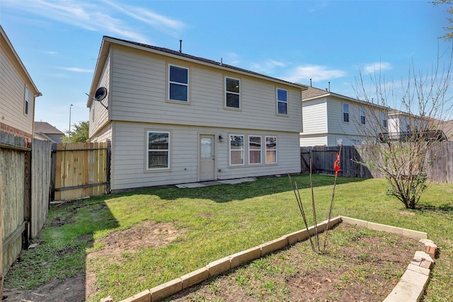 rear view of property with a garden, a fenced backyard, and a lawn