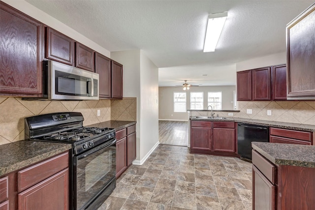 kitchen with dishwasher, black range with gas stovetop, stainless steel microwave, dark countertops, and a sink
