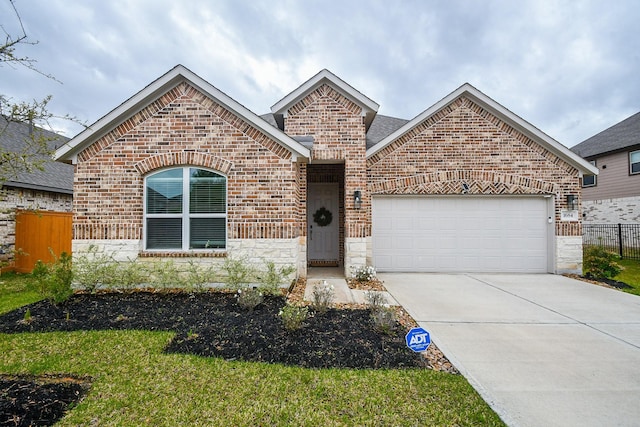 view of front of house featuring brick siding, driveway, fence, and an attached garage