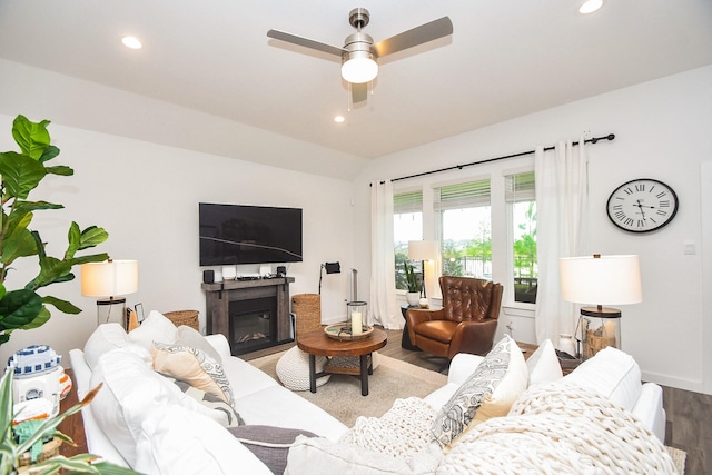 living area featuring lofted ceiling, wood finished floors, recessed lighting, and a ceiling fan