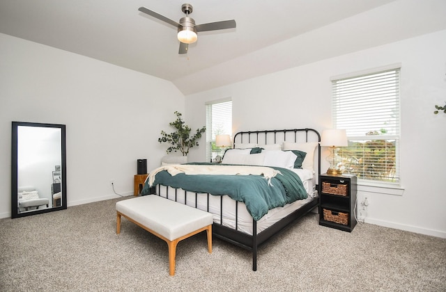 carpeted bedroom with baseboards, vaulted ceiling, and a ceiling fan
