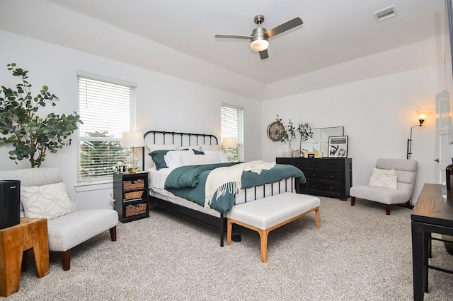 carpeted bedroom with visible vents and a ceiling fan