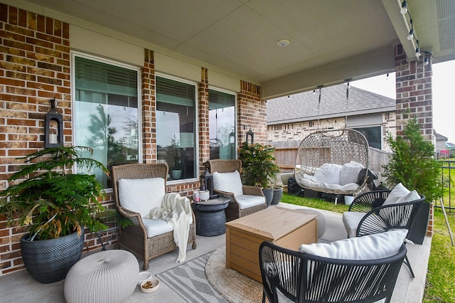 view of patio with an outdoor hangout area and fence