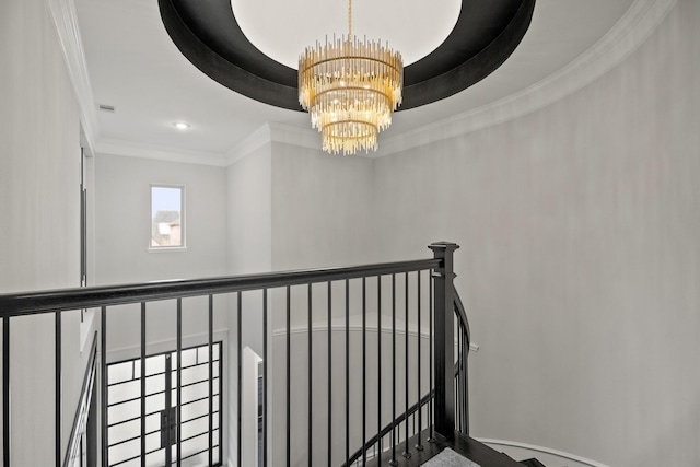 stairway featuring a notable chandelier and crown molding