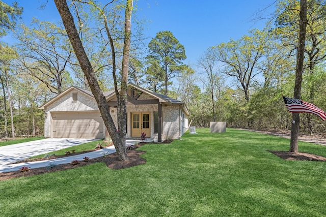 20302 Peach Dr, Huntsville, TX 77320 - view of grassy yard featuring driveway and a garage