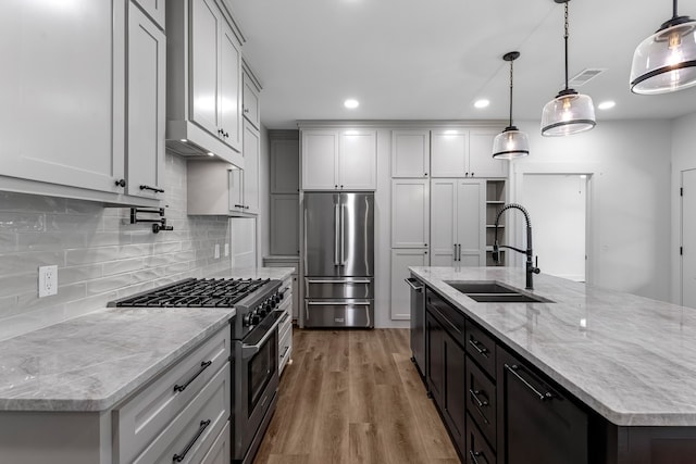 20302 Peach Dr, Huntsville, TX 77320 - kitchen featuring stainless steel appliances, a sink, recessed lighting, a kitchen island with sink, and tasteful backsplash
