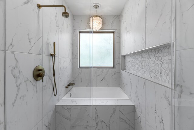 20302 Peach Dr, Huntsville, TX 77320 - bathroom featuring a marble finish shower, tile walls, and a chandelier
