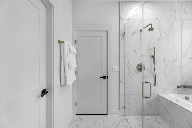 20302 Peach Dr, Huntsville, TX 77320 - bathroom with a marble finish shower, marble look tiles, a bath, and baseboards