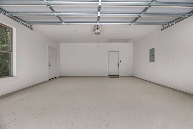 20302 Peach Dr, Huntsville, TX 77320 - garage featuring electric panel and a garage door opener