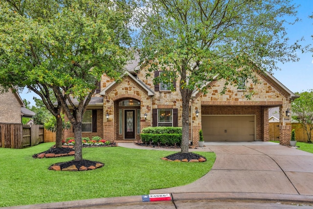 24606 Bennetts Ridge Ln, Porter, TX 77365 - view of front facade with driveway, brick siding, a garage, and stone siding