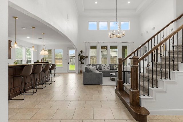 24606 Bennetts Ridge Ln, Porter, TX 77365 - entrance foyer with a chandelier, stairs, light tile patterned flooring, recessed lighting, and arched walkways