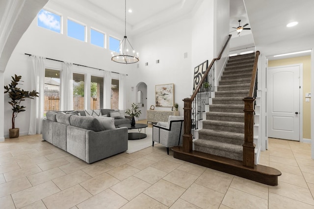 24606 Bennetts Ridge Ln, Porter, TX 77365 - living room with stairs, baseboards, light tile patterned floors, a ceiling fan, and a chandelier