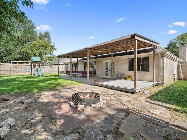902 Rolling Mill Dr, Sugar Land, TX 77498 - rear view of house featuring brick siding, a patio area, french doors, a lawn, and a fire pit