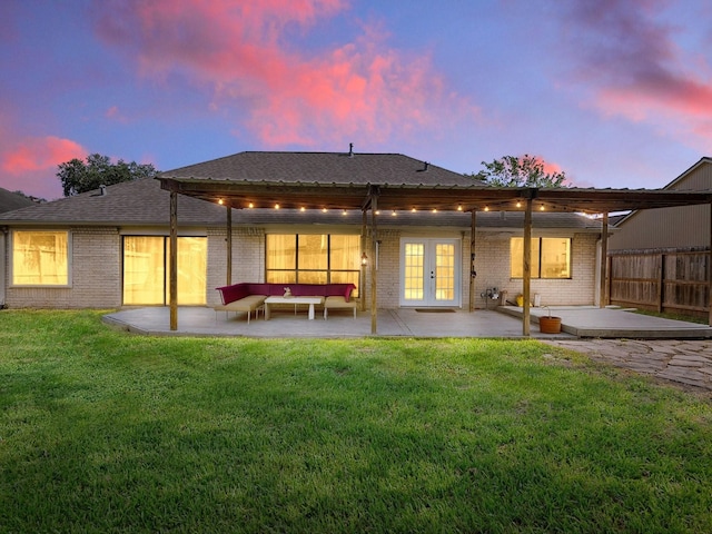 902 Rolling Mill Dr, Sugar Land, TX 77498 - back of property featuring a patio, french doors, brick siding, an outdoor living space, and a lawn