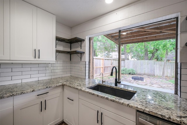 902 Rolling Mill Dr, Sugar Land, TX 77498 - kitchen with white cabinets, open shelves, a sink, dishwasher, and tasteful backsplash
