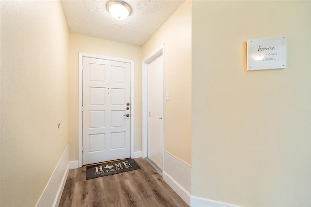 13623 Wimbledon Oaks Dr, Houston, TX 77065 - doorway with wood finished floors, a textured ceiling, and baseboards