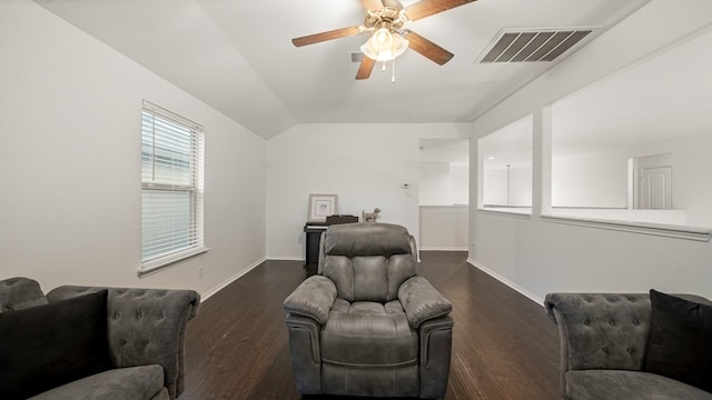sitting room featuring dark wood-style flooring, baseboards, vaulted ceiling, visible vents, and ceiling fan