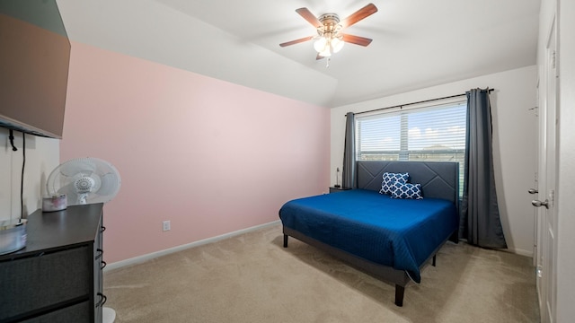 bedroom featuring light colored carpet, baseboards, a ceiling fan, and vaulted ceiling