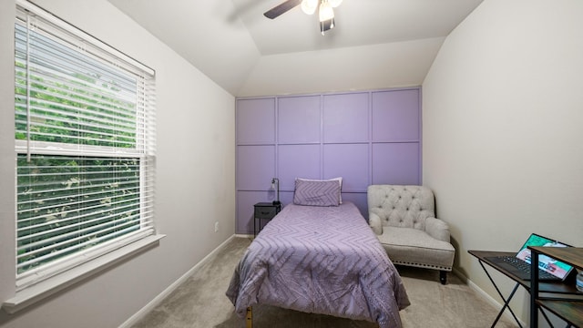 bedroom with baseboards, light colored carpet, a ceiling fan, and lofted ceiling