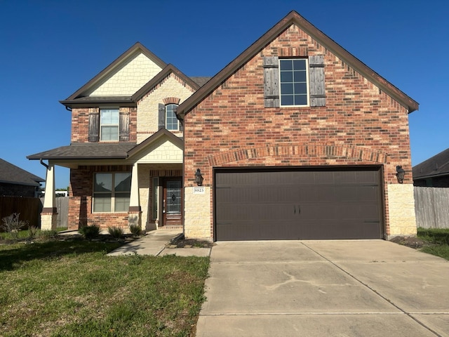 view of front facade with fence, driveway, brick siding, a front yard, and a garage