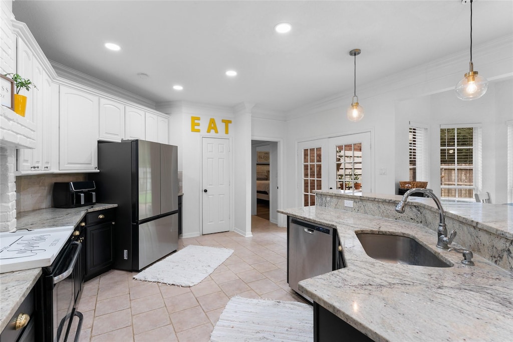 3821 Happy Hollow Ln, Montgomery, TX 77356 - kitchen with light tile patterned floors, stainless steel appliances, decorative backsplash, a sink, and white cabinets
