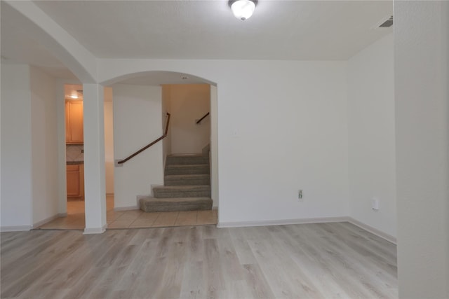 interior space with visible vents, baseboards, light wood-type flooring, and stairs