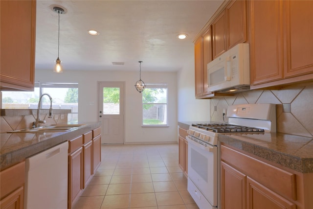 kitchen featuring tasteful backsplash, tile counters, a sink, and white appliances