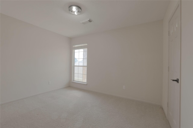 empty room featuring visible vents, baseboards, and carpet flooring